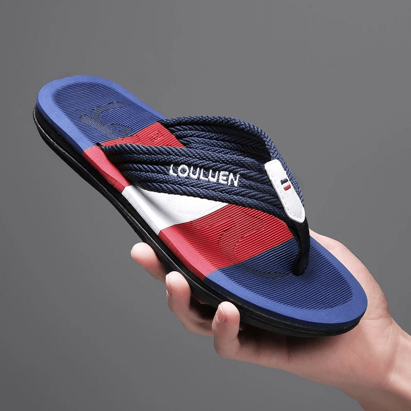 Red, white, and blue men's beach flip flop with breathable nylon upper, supportive EVA insole, durable rubber outsole in hand. Model SF1077.